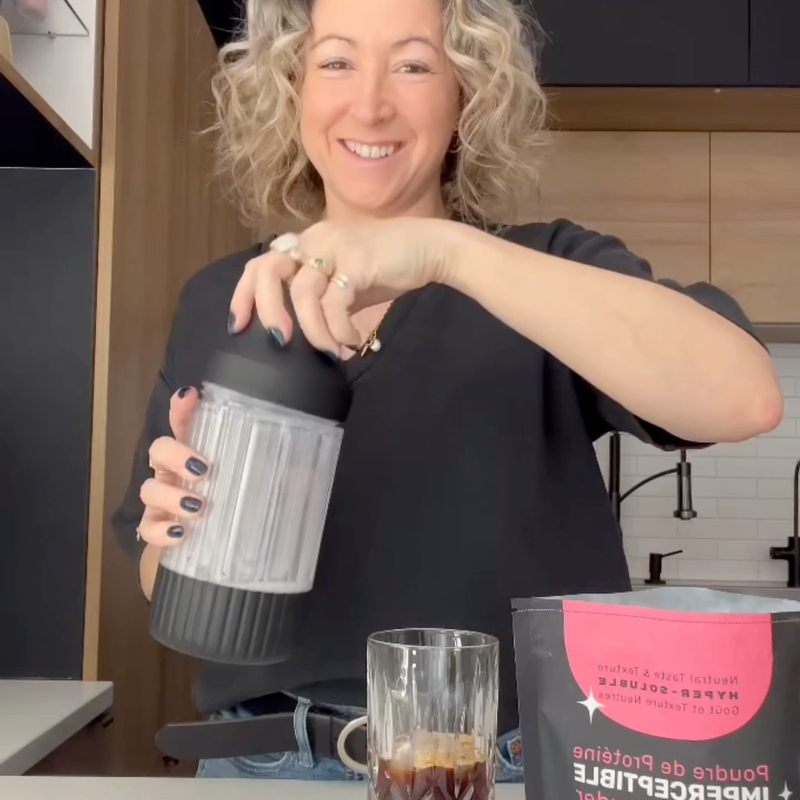 Woman with ELEVO Nutrition and iced coffee