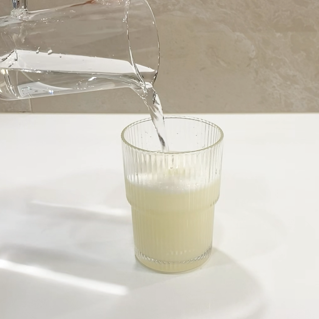 ELEVO Nutrition protein powder on a glass of lemonade