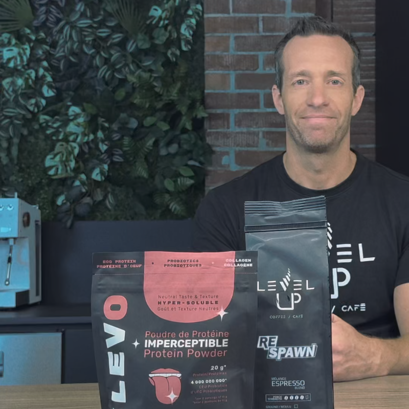 Man holding ELEVO protein powder package smiling