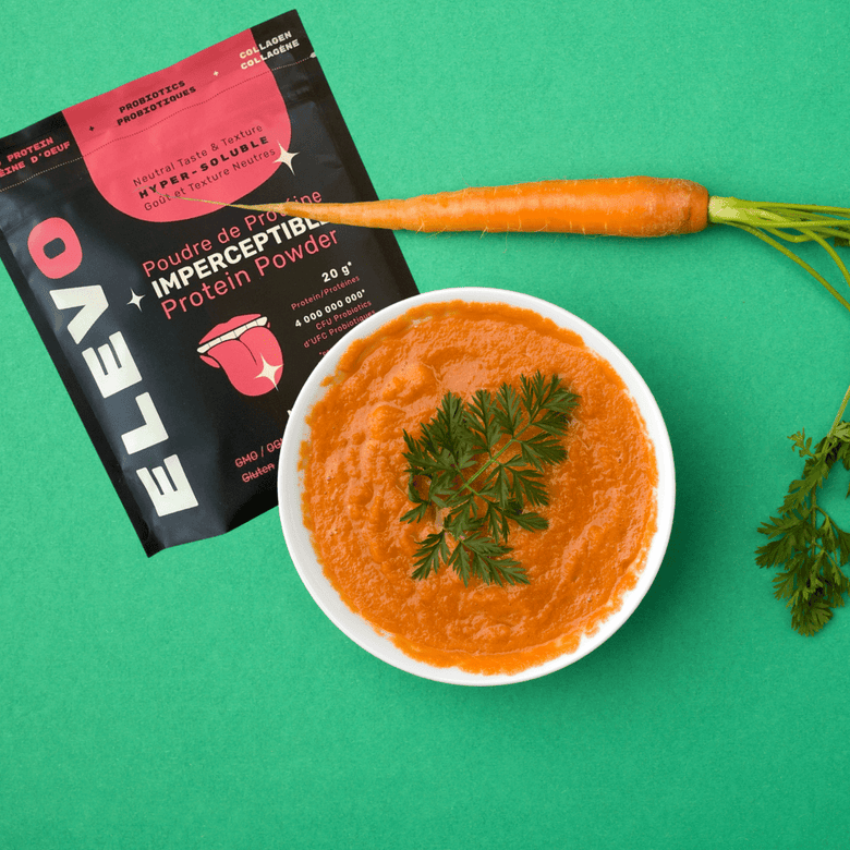 Bowl of carrot puree with ELEVO Nutrition protein powder and carrots